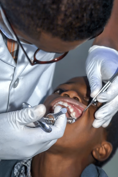 a little boy having a dental examination and cleaning