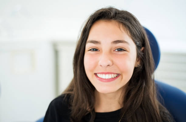 a girl smiling widely at the camera