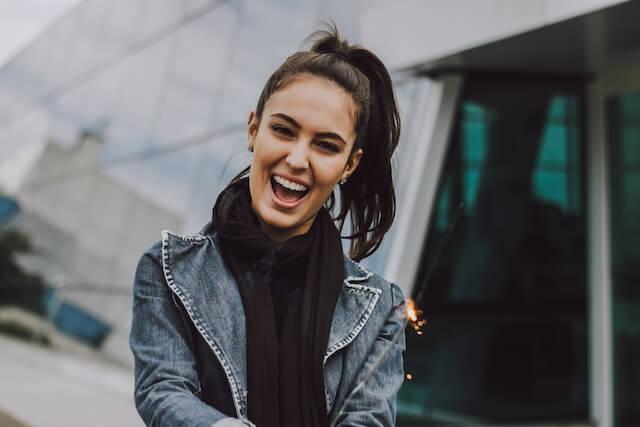 a woman with a ponytail smiling