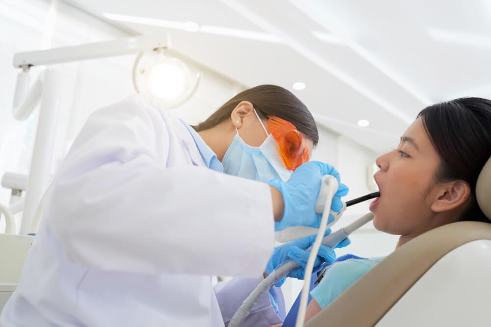 a female receiving dental care from a dentist