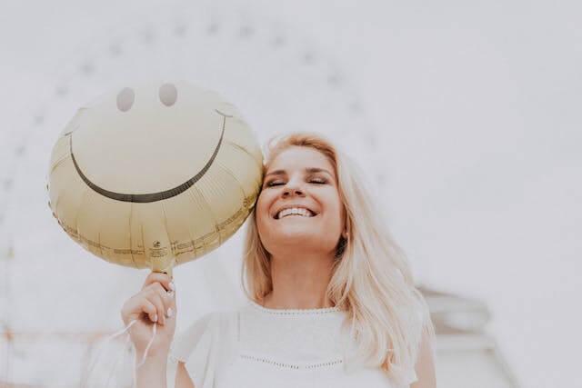 a woman smiling with a balloon