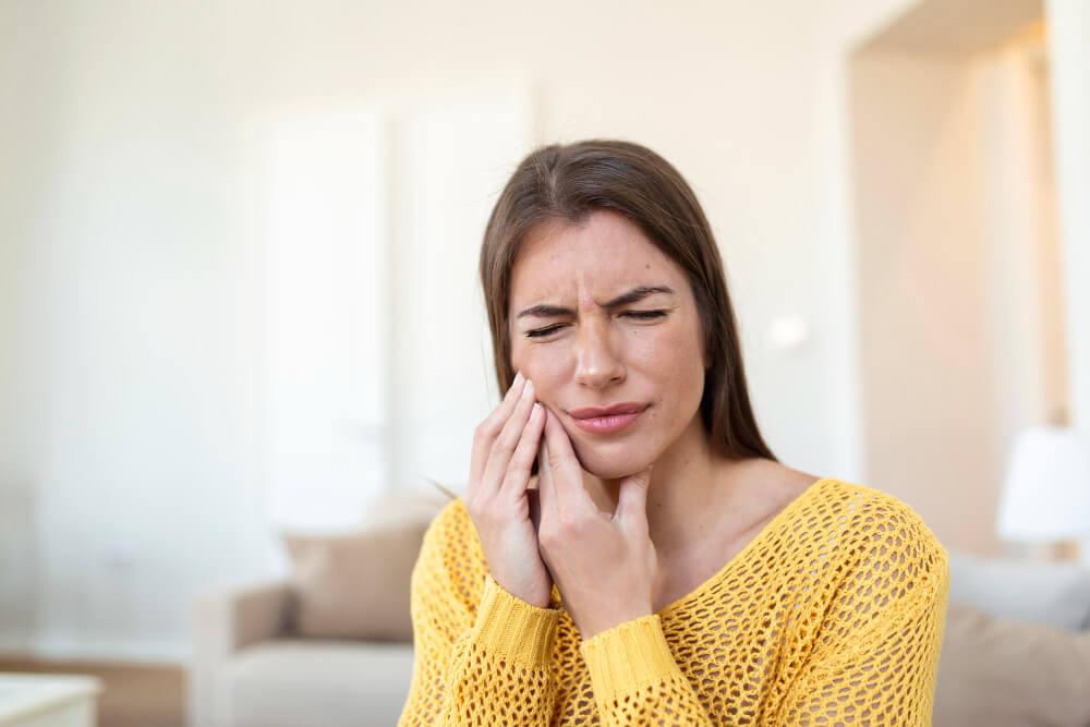 image of a woman suffering from tooth pain