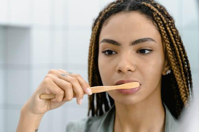 a woman brushing her teeth