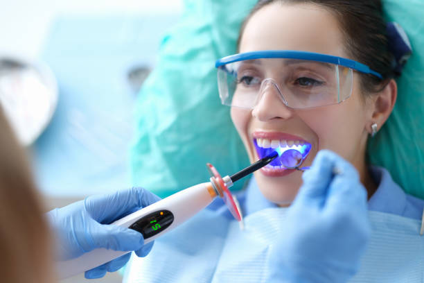 image of a woman with protective eye gear during a dental treatment